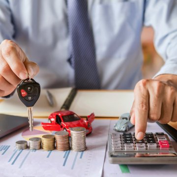 10 best extended car warranty services man holding car keys and using pocket calculator red toy car money coins on the table laptop 